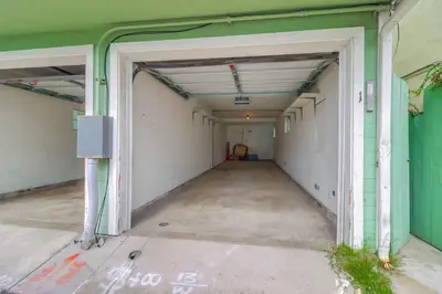 an empty hallway of a building with an open door at Half block to bay steps to ocean AC large patio in San Diego