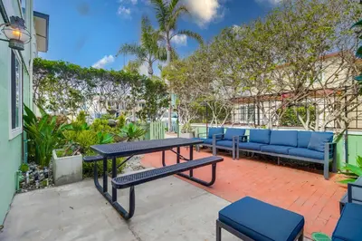 a patio with a picnic table and blue benches at Half block to bay steps to ocean AC large patio in San Diego