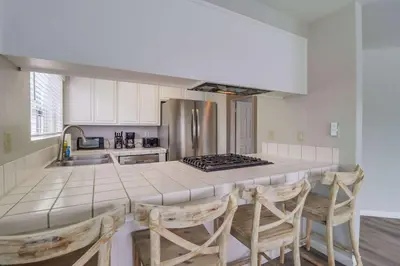 a kitchen with a counter top and a kitchen island at Steps to bay & ocean Belmont Park dining in San Diego