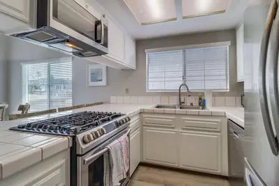 a kitchen with a stove and a sink at Steps to bay & ocean Belmont Park dining in San Diego