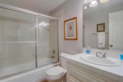 a bathroom with a sink and a toilet and a shower at Steps to bay & ocean Belmont Park dining in San Diego