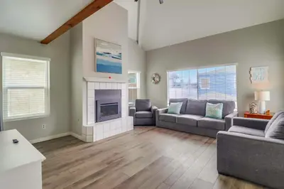 a living room with two couches and a fireplace at Steps to bay & ocean Belmont Park dining in San Diego