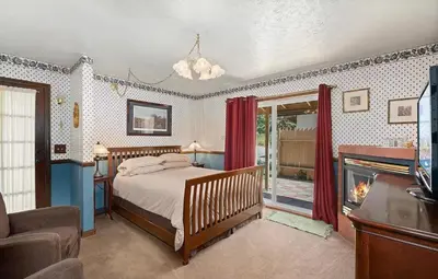 a bedroom with a bed and a fireplace at Eaglenest Inn with Pool & Seasonal SPA in Julian
