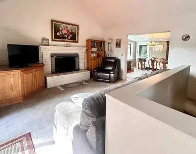 a living room with a fireplace and a television at Eaglenest Inn with Pool & Seasonal SPA in Julian