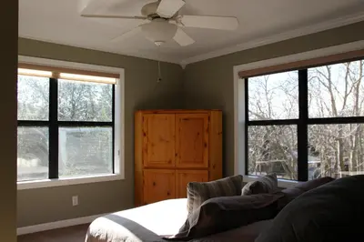 a bedroom with windows and a bed and a ceiling fan at Whole House at Eaglenest Inn with Pool & Seasonal SPA in Julian