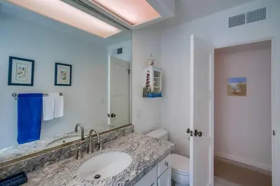 a bathroom with a sink and a toilet at Luxury summer house feet from bay & ocean patios in San Diego