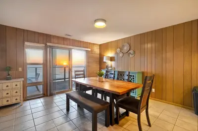 a dining room with a wooden table and chairs at Oceanfront Getaway Ocean Views Fire Pit BBQ Beach Access in Carlsbad