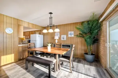 a kitchen and dining room with a wooden table and chairs at Oceanfront Getaway Ocean Views Fire Pit BBQ Beach Access in Carlsbad