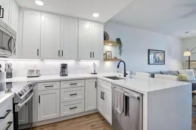 a kitchen with white cabinets and a sink at 2003 Costa Del Mar Road - Unit 676 in Carlsbad