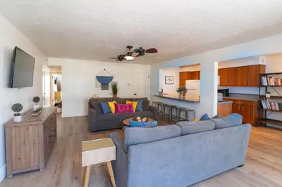 a living room with a couch and a table at Beachwalk Villas in Carlsbad
