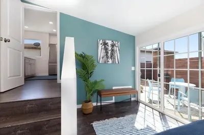a living room with blue walls and a table and a plant at Comstock in San Diego