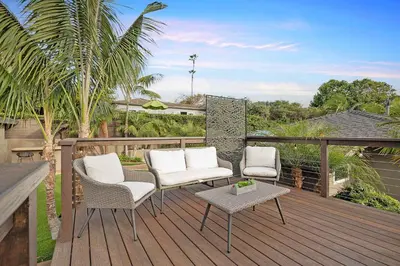 a deck with three chairs and a table and a table at Ocean Views w Stunning Sunsets by the Firepit in San Diego