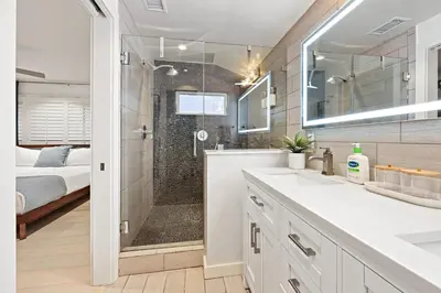 a bathroom with a shower and a sink and a tub at Ocean Views w Stunning Sunsets by the Firepit in San Diego