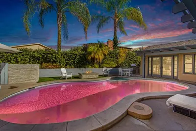 a swimming pool in a house with a pink floor at MV Retreat Pool Spa Fire Pit Family Friendly in Mission Viejo