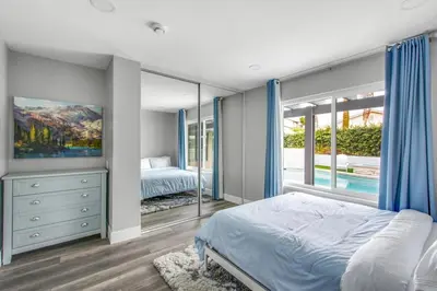 a bedroom with a bed and a large window at MV Retreat Pool Spa Fire Pit Family Friendly in Mission Viejo