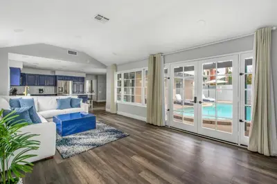 a living room with a white couch and a pool at MV Retreat Pool Spa Fire Pit Family Friendly in Mission Viejo