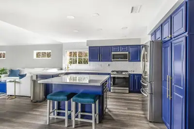a kitchen with blue cabinets and blue stools at MV Retreat Pool Spa Fire Pit Family Friendly in Mission Viejo