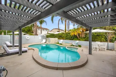 a swimming pool with a pergola on a patio at MV Retreat Pool Spa Fire Pit Family Friendly in Mission Viejo