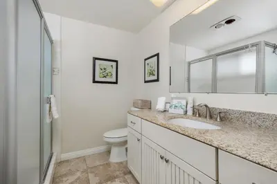a white bathroom with a sink and a toilet at Bask in the Breeze - DMBC146N in Solana Beach