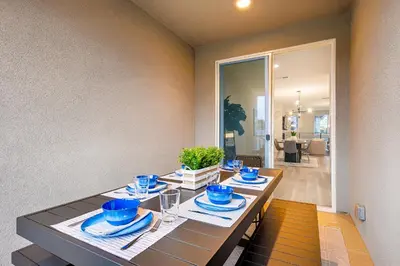 a dining room with a table with blue dishes on it at 343 Oak Avenue in Carlsbad