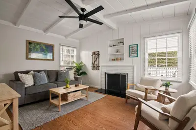 a living room with a couch and a fireplace at Coastal Retreat 1BR Steps to Ocean & Peek Views in San Diego