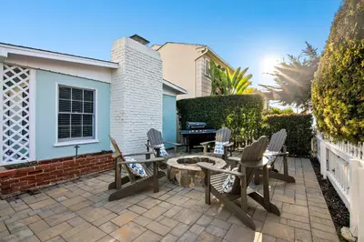 a patio with chairs and a table and a fire pit at Coastal Retreat 1BR Steps to Ocean & Peek Views in San Diego