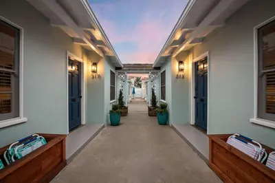 an empty hallway of a house with benches and windows at Coastal Retreat 1BR Steps to Ocean & Peek Views in San Diego