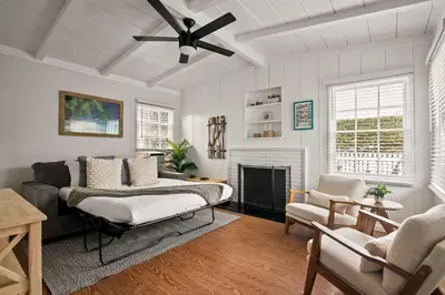 a living room with a bed and a fireplace at Coastal Retreat 1BR Steps to Ocean & Peek Views in San Diego