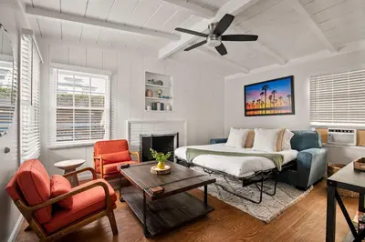 a living room with a bed and a couch at Beautiful Windansea Beach Compound Steps to Sand in San Diego