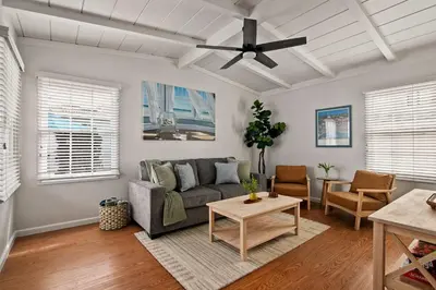 a living room with a couch and a ceiling fan at Ocean Escape 1BR Walk to Windansea Beach in San Diego