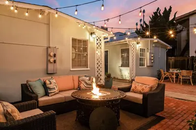 a patio with a couch and a table and lights at Ocean Escape 1BR Walk to Windansea Beach in San Diego