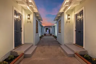 an empty hallway of a house with blue doors at Ocean Escape 1BR Walk to Windansea Beach in San Diego