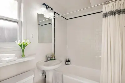 a white bathroom with a sink and a toilet at Beachside 1BR Haven Near Ocean & Outdoor Space in San Diego