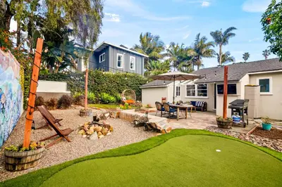 a backyard with a fire pit and a house at Cozy Coastal Stay Hot Tub & Putting Green in San Diego