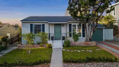 a house with a green door in a yard at Cozy Coastal Stay Hot Tub & Putting Green in San Diego