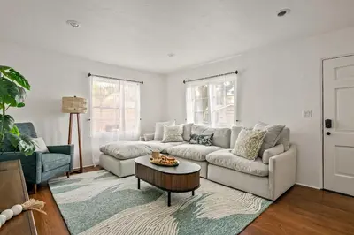 a living room with a couch and a table at Cozy Coastal Stay Hot Tub & Putting Green in San Diego