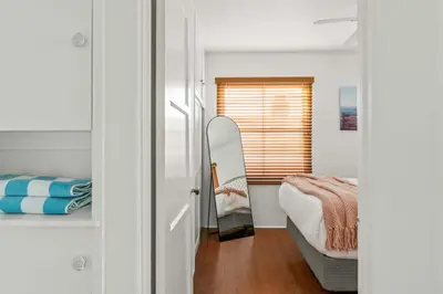 a bedroom with a bed and a mirror in it at Cozy Coastal Stay Hot Tub & Putting Green in San Diego
