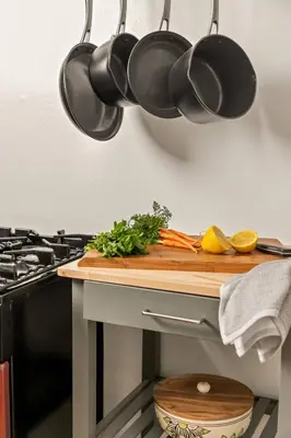 a kitchen counter with pots and pans hanging from a wall at Cozy Coastal Stay Hot Tub & Putting Green in San Diego