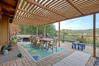 a wooden pergola with a table and chairs on a patio at 3046 Skycrest Drive in Fallbrook