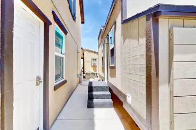 a hallway with stairs between two buildings at Outdoor Oasis with Pool and Hot Tub Perris Getaway in Perris