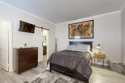 a bedroom with a bed and a dresser in it at Outdoor Oasis with Pool and Hot Tub Perris Getaway in Perris