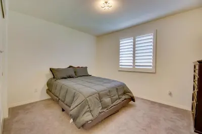 a bedroom with a bed and a window at Luxurious and Spacious Family Duplex in Menifee! in Menifee