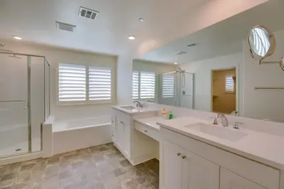 a bathroom with two sinks and a shower and a tub at Luxurious and Spacious Family Duplex in Menifee! in Menifee