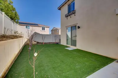 a small backyard with a green lawn at Luxurious and Spacious Family Duplex in Menifee! in Menifee