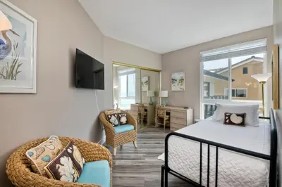 a bedroom with a bed and a chair at 901 S Pacific in Oceanside