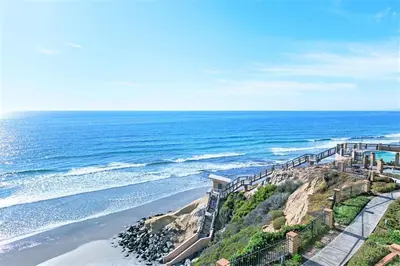 an aerial view of the ocean with a staircase on a cliff at Dolphin's Drift - DMST50 in Solana Beach