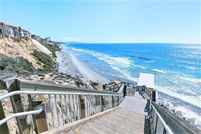 a stairway leading down to a beach with the ocean at Dolphin's Drift - DMST50 in Solana Beach