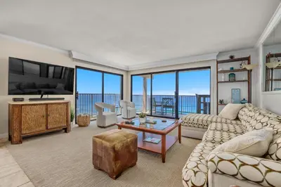 a living room with a couch and a table and a tv at Sunglow Horizon - DMBC873B in Solana Beach