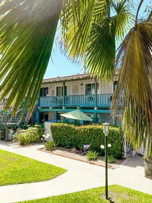 a resort building with a palm tree at 3080 Lincoln - Unit 12 in Carlsbad