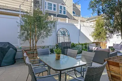 a patio with a table and chairs and a fence at 3690 Carlsbad Boulevard - Unit C in Carlsbad